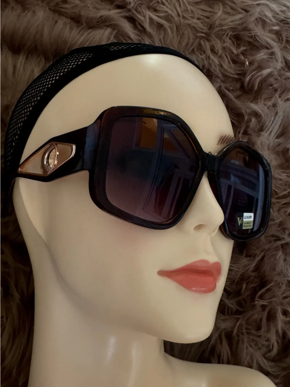 Futuristic sunglasses with large button detail on the sides